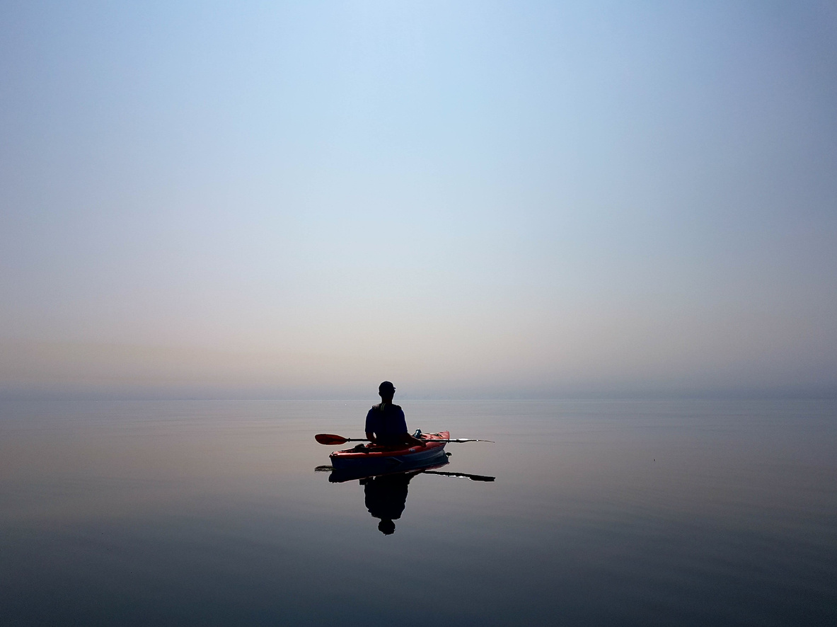 Man kayaking calm waters